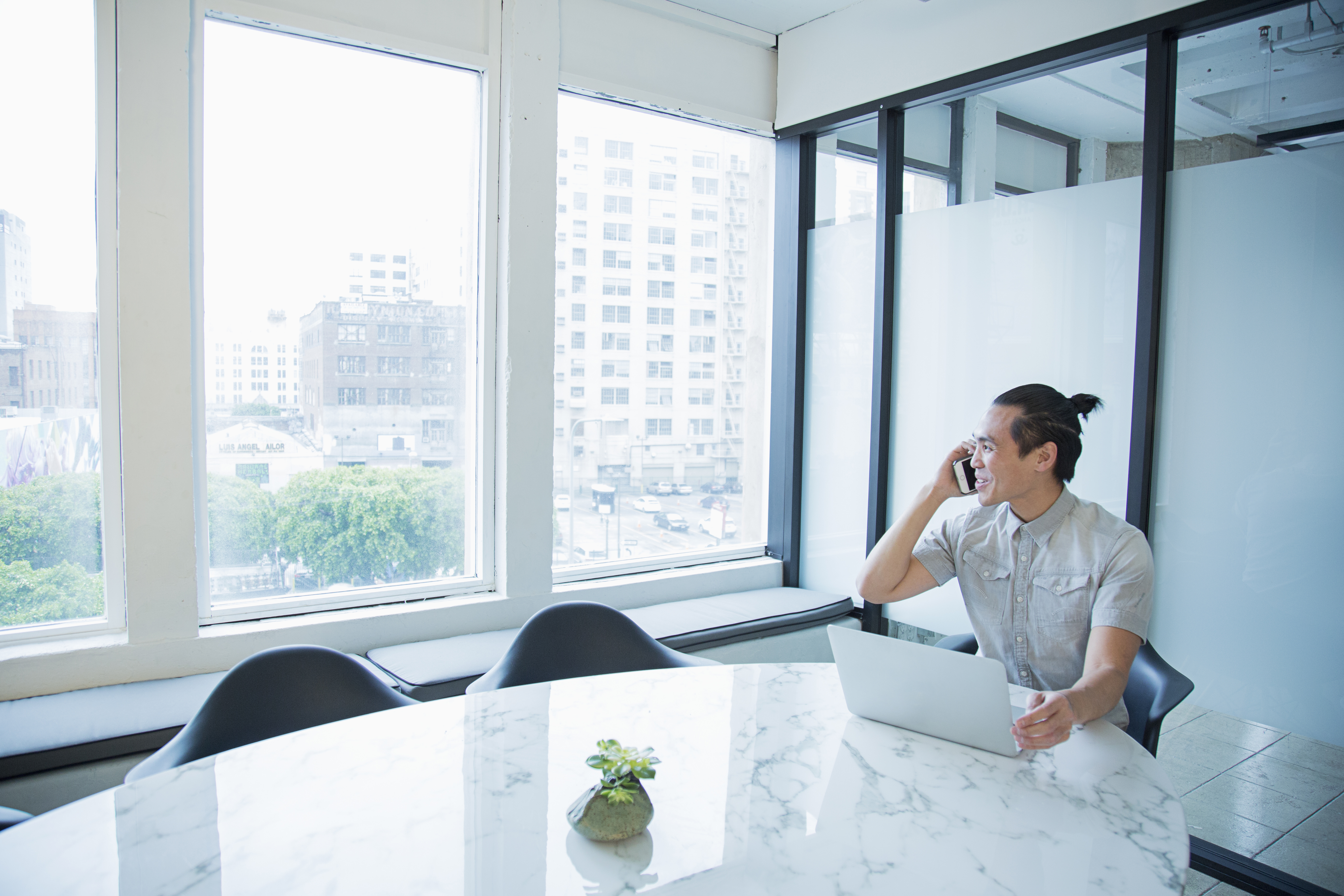 Man on phone in front of computer